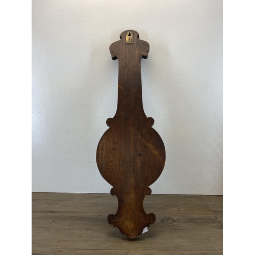 586 - A 19th century Nicholson & Cartner of Carlisle carved oak barometer - approx. 82cm high