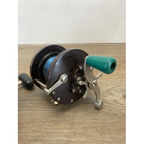 566 - Four vintage multiplier fishing reels, three Penn and one other.