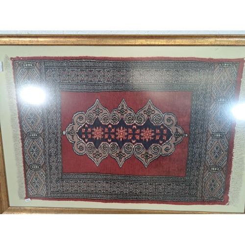 220 - A framed Persian rug - approx. 114cm high x 77cm wide