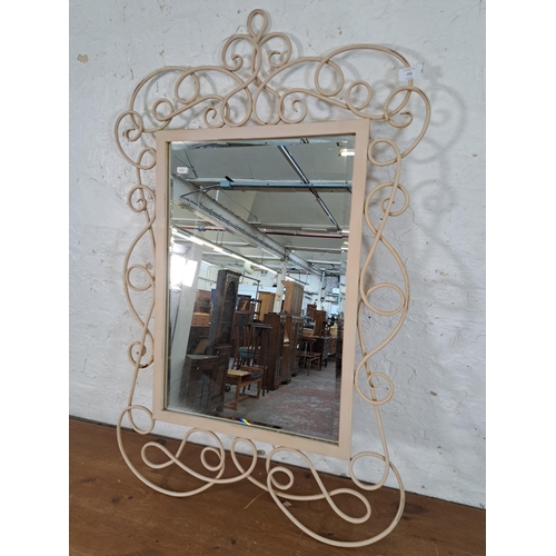 222 - A contemporary scrolled metal framed bevelled edge wall mirror - approx. 110cm high x 70cm wide