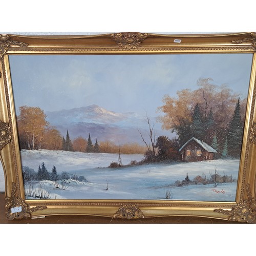 210A - A gilt framed oil on canvas of a winter landscape scene signed lower right - approx. 73cm high x 105... 