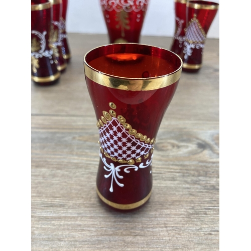 255 - A Venetian ruby red and gold glass seven piece drinking set - decanter approx. 30cm high