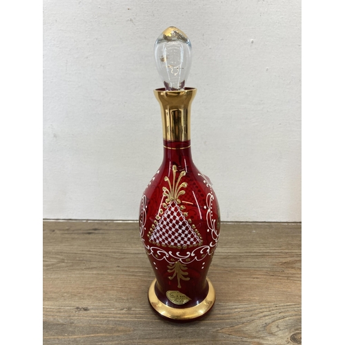 255 - A Venetian ruby red and gold glass seven piece drinking set - decanter approx. 30cm high