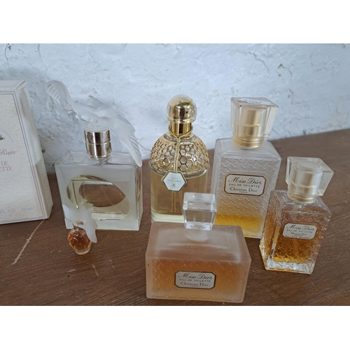 2388 - A collection of part used perfumes to include Guerlain, three Miss Dior eau de toilette, Estée Laude... 