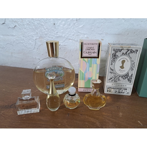 2388 - A collection of part used perfumes to include Guerlain, three Miss Dior eau de toilette, Estée Laude... 