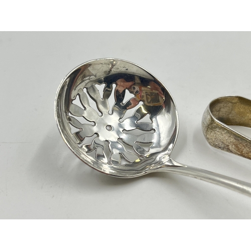 2286 - Two pieces of sterling silver, one spoon and one pair of sugar tongs - approx. 29g