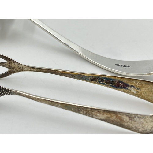 2286 - Two pieces of sterling silver, one spoon and one pair of sugar tongs - approx. 29g