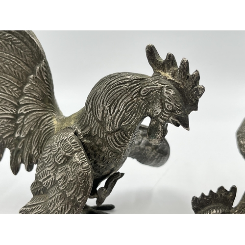 2345A - A pair of French metal fighting rooster figurines - largest approx. 18cm high