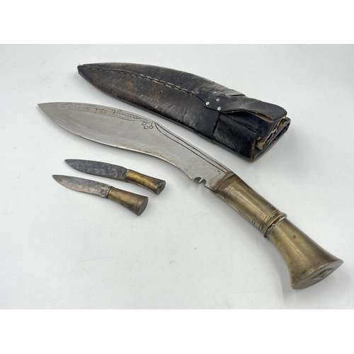 2360 - A kukri knife with sheath and two further small knives