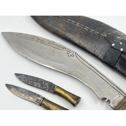 2360 - A kukri knife with sheath and two further small knives