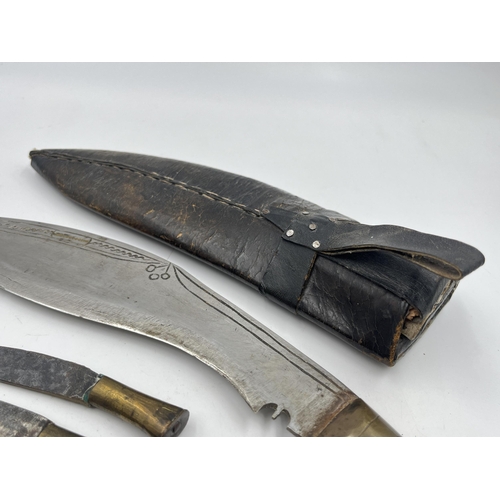 2360 - A kukri knife with sheath and two further small knives