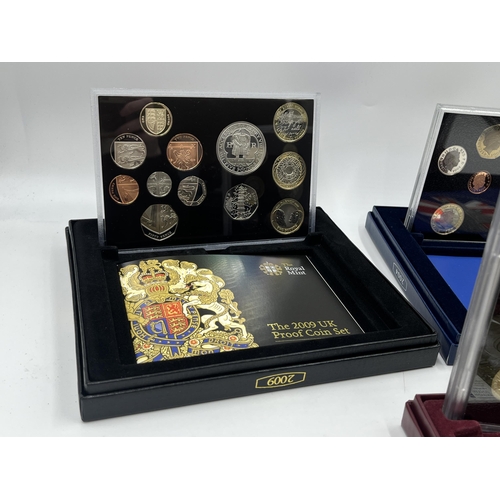 2365 - A collection of cased coin sets to include 1997, 2001, 2003, 2004, 2005, 2008, 2009 five pound to on... 