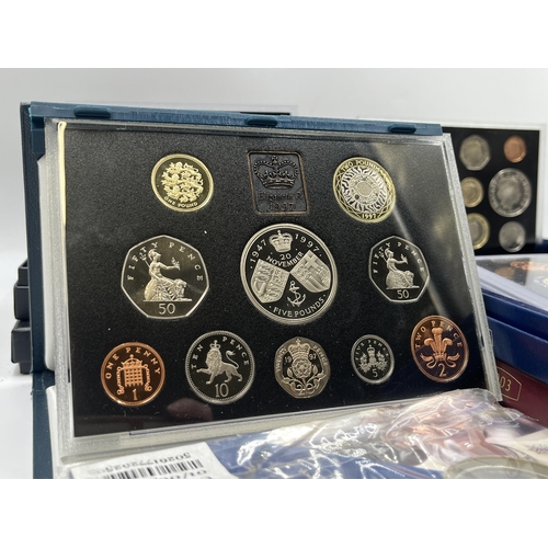 2365 - A collection of cased coin sets to include 1997, 2001, 2003, 2004, 2005, 2008, 2009 five pound to on... 