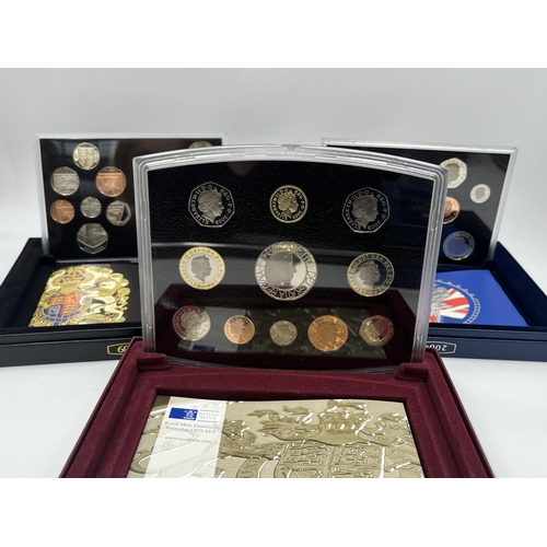 2365 - A collection of cased coin sets to include 1997, 2001, 2003, 2004, 2005, 2008, 2009 five pound to on... 