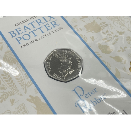 2366 - Five items, one Beatrix Potter 50p coin collector album containing five 50p coins, two boxed silver ... 