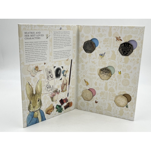 2366 - Five items, one Beatrix Potter 50p coin collector album containing five 50p coins, two boxed silver ... 