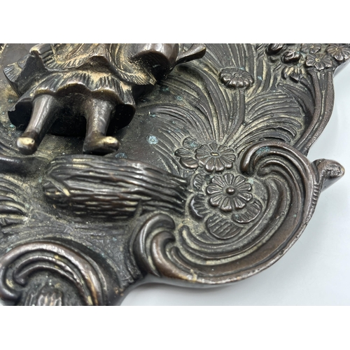 2369 - A bronzed cast metal figural wall plaque with floral decoration - approx. 32cm high