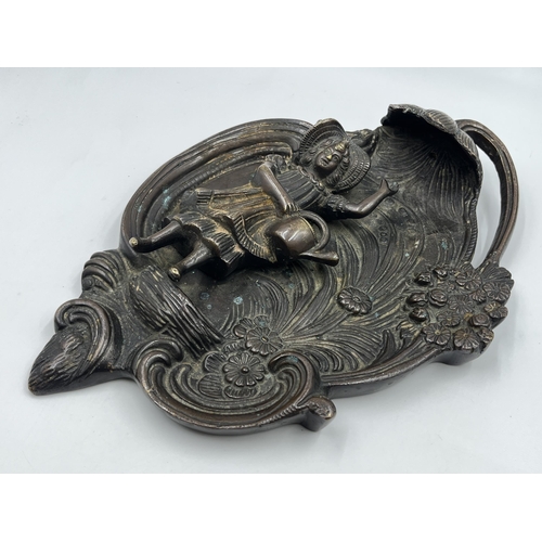 2369 - A bronzed cast metal figural wall plaque with floral decoration - approx. 32cm high