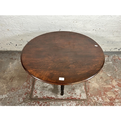 146 - An early 20th century oak tilt top occasional table on bobbin turned supports - approx. 61cm high x ... 