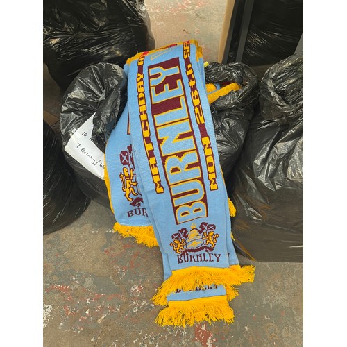 965A - Three bags containing a large quantity of sports scarves and t-shirts to include Huddersfield, Manch... 