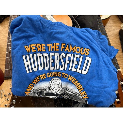 966A - Three bags containing a large quantity of sports scarves and t-shirts to include Huddersfield, Engla... 