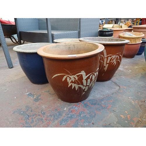 876 - Five glazed terracotta planters