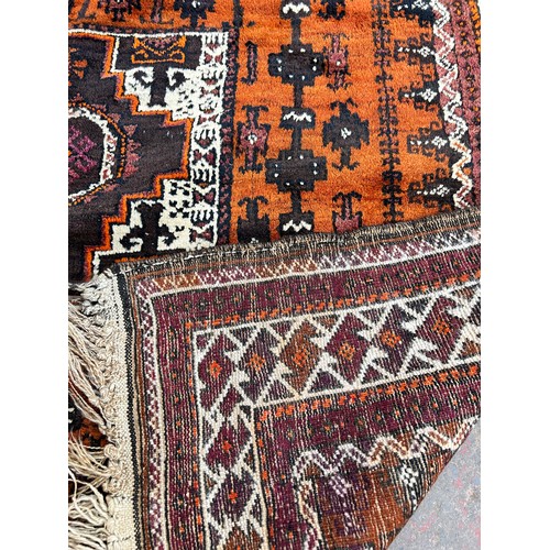 152 - A mid 20th century hand knotted orange rug - approx. 298cm long x 135cm wide