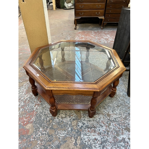 80 - A mahogany and bevelled glass top octagonal two tier coffee table - approx. 41cm high x 96cm wide x ... 