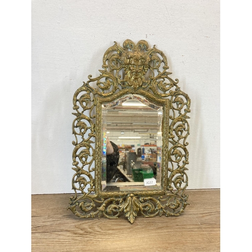 331 - A 19th century cast brass figural wall mirror with Bacchus top and bevelled glass plate - approx. 37... 