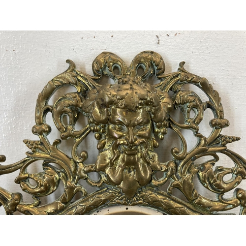 331 - A 19th century cast brass figural wall mirror with Bacchus top and bevelled glass plate - approx. 37... 