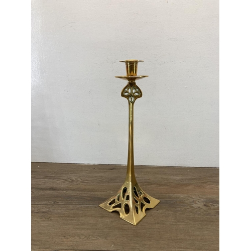 334 - An Art Nouveau style brass candlestick - approx. 37cm high