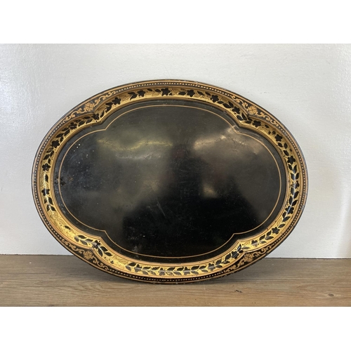 338 - Four pieces of antique metalware, two Victorian black and gold plated serving trays, one 19th centur... 