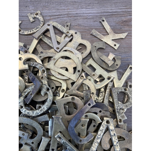 340 - A large quantity of brass wall mountable letters and numbers - each approx. 7cm high