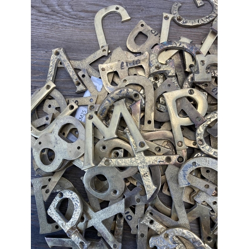 340 - A large quantity of brass wall mountable letters and numbers - each approx. 7cm high