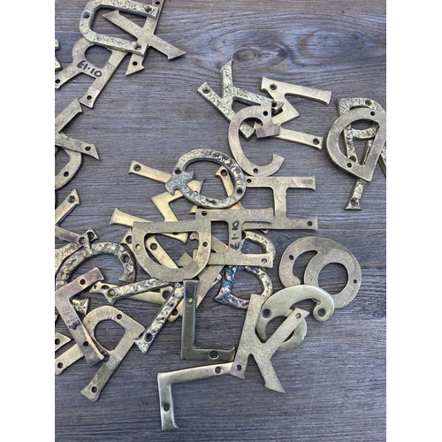 340 - A large quantity of brass wall mountable letters and numbers - each approx. 7cm high