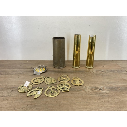 353 - A collection of metalware, three brass shell cases, one vintage AA badge serial no. 4A92447 and a co... 