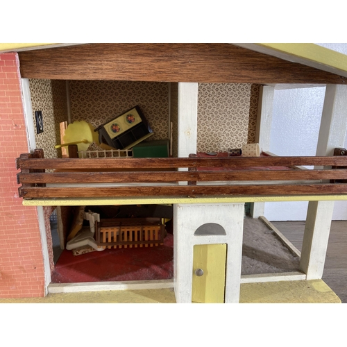 370 - Two items, one mid 20th century scratch built two storey doll's house and one scratch built doll's h... 