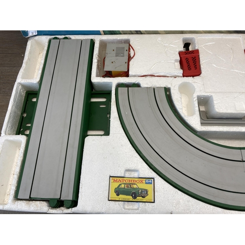 374 - Two Matchbox items, one motorised motorway slot car set and one Vincent series C black shadow model ... 