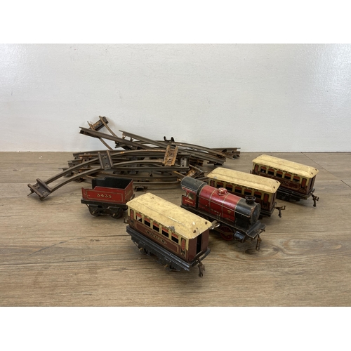 395 - A collection of vintage Meccano tin plate clockwork model railway items to include locomotive, coach... 