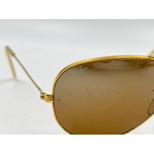 2358 - A cased pair of Ray-Ban gold tone Aviator sunglasses