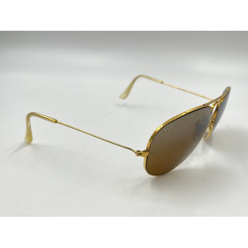 2358 - A cased pair of Ray-Ban gold tone Aviator sunglasses