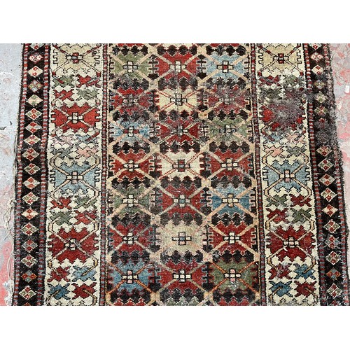 138 - An antique hand woven rug - approx. 325cm x 100cm