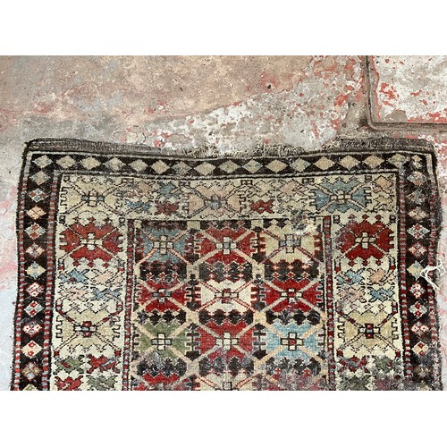 138 - An antique hand woven rug - approx. 325cm x 100cm