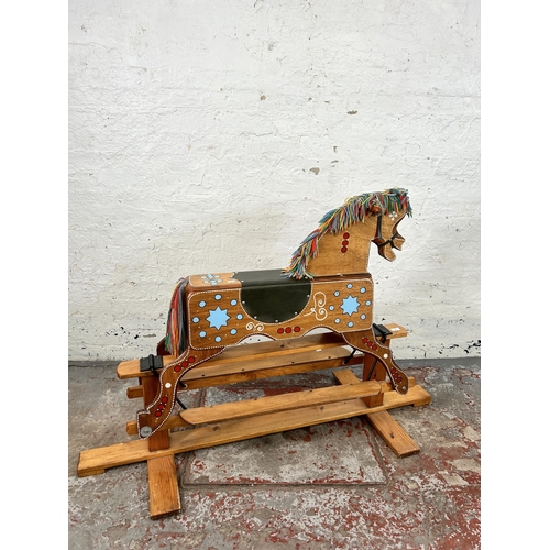 162 - A 1980s hand painted wooden rocking horse on pine stand - approx. 94cm high x 58cm wide x 147cm long