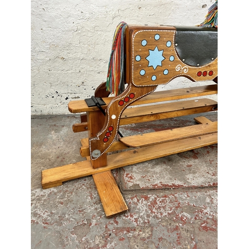 162 - A 1980s hand painted wooden rocking horse on pine stand - approx. 94cm high x 58cm wide x 147cm long