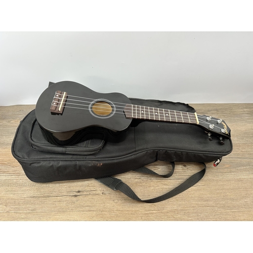 742 - A cased Tiger Soprano ukulele with heavy duty music stand and sheet music