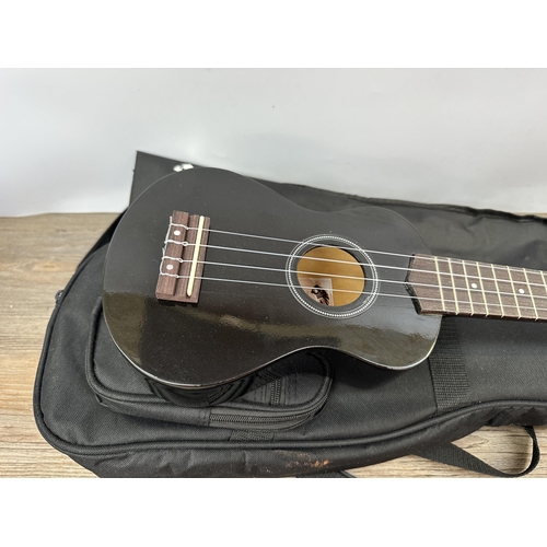 742 - A cased Tiger Soprano ukulele with heavy duty music stand and sheet music