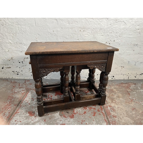 100 - A 17th century style carved oak nest of tables