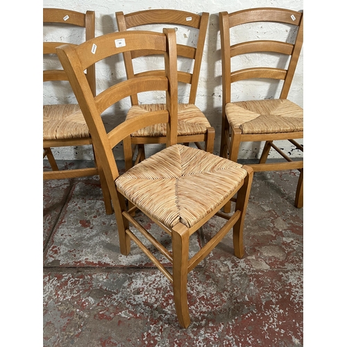 102 - Four beech and rush seated dining chairs