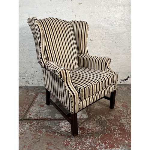 103 - A Georgian style fabric upholstered wingback armchair